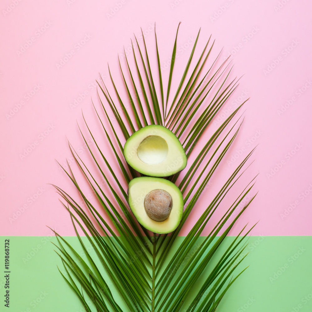 Obraz Dyptyk Ripe Avocado on palm leaf on a