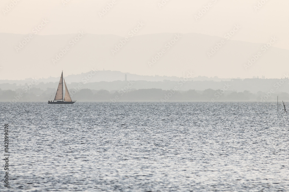 Obraz Kwadryptyk A small sailboat on a lake,