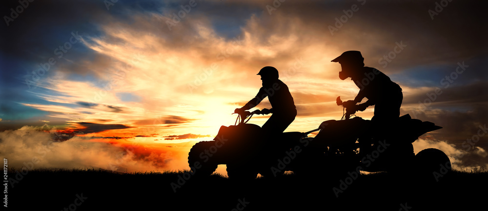 Fototapeta Two young men ride an ATV on