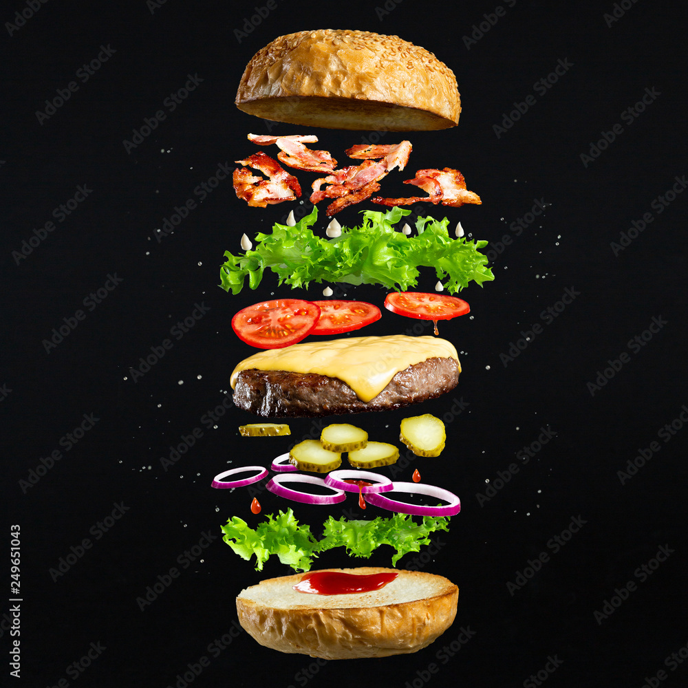 Obraz Tryptyk Floating burger isolated on