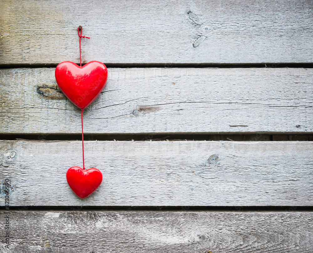 Obraz Tryptyk Two hanging red hearts on