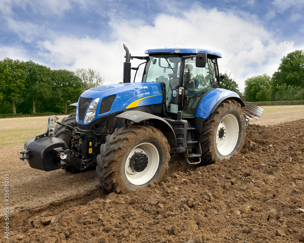 Fototapeta Tractor Ploughing Front View