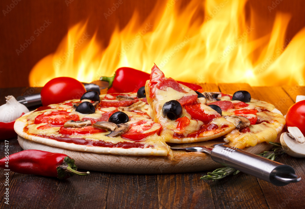 Fototapeta Hot pizza with oven fire on
