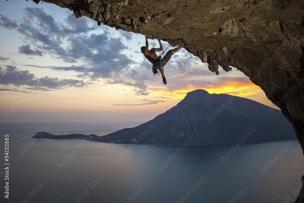 Obraz na płótnie Male rock climber at sunset.