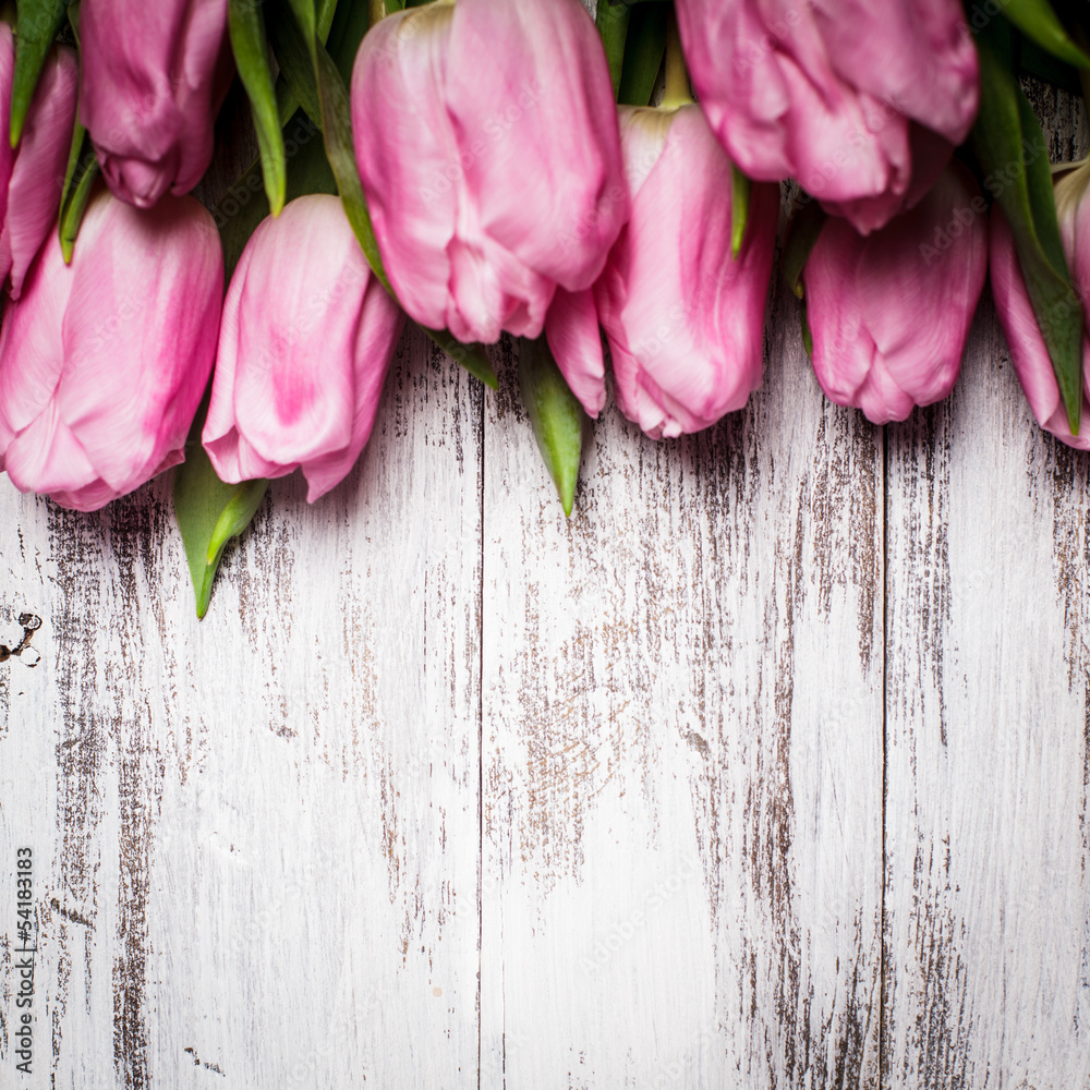 Fototapeta Pink tulips over wooden table