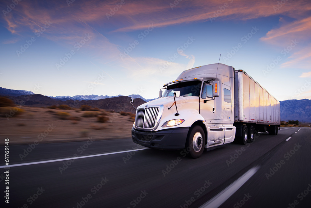 Fototapeta Truck and highway at sunset -