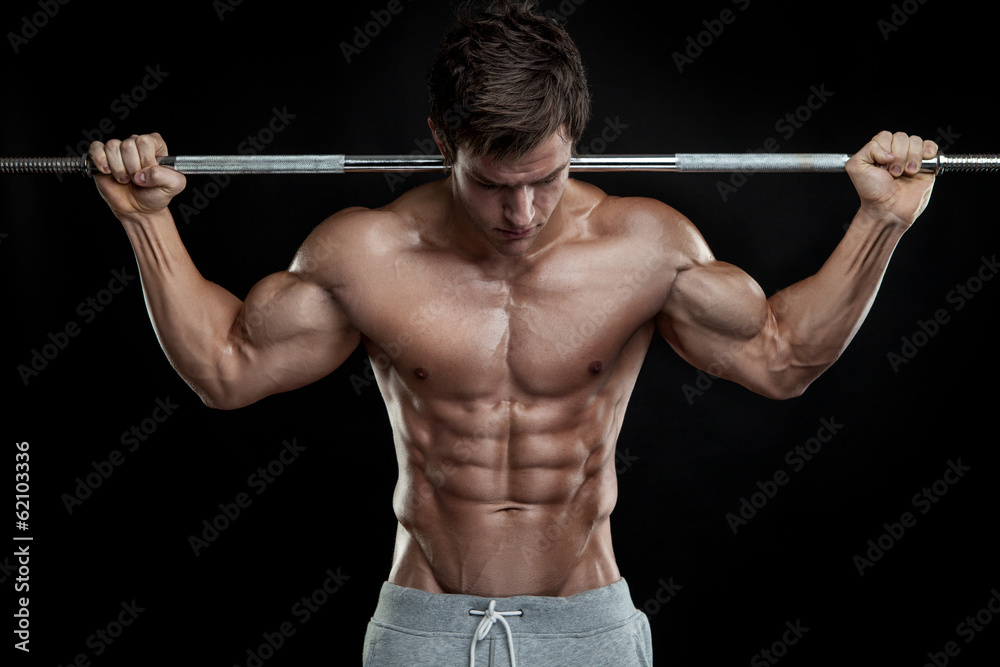 Fototapeta Muscular bodybuilder guy doing