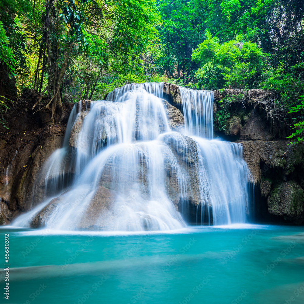 Fototapeta Deep forest waterfall at
