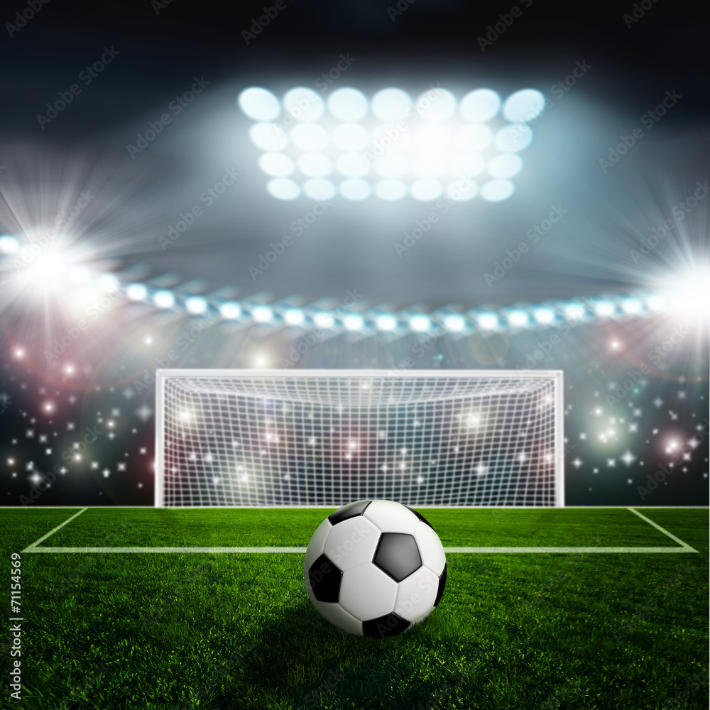 Fototapeta Soccer ball on green stadium