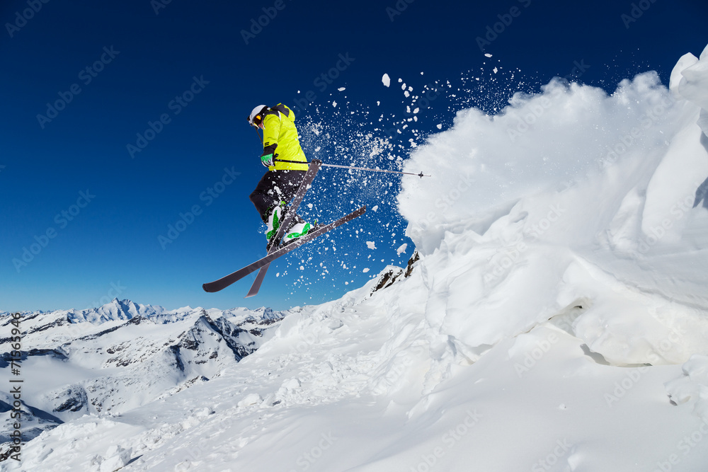 Fototapeta Alpine skier jumping from hill