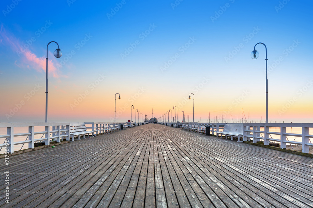Obraz Tryptyk Sunrise at wooden pier in