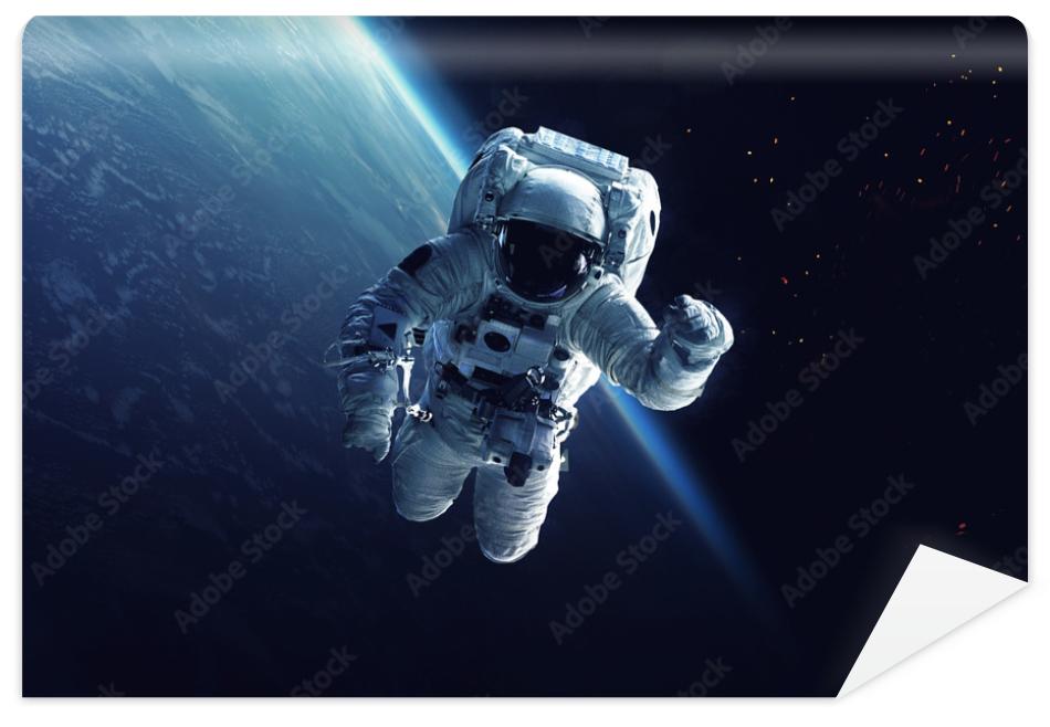 Fototapeta Astronaut at spacewalk. Cosmic