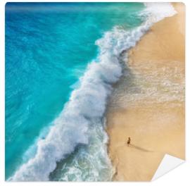 Fototapeta View of a man on the beach on