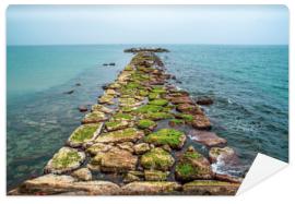 Fototapeta Stone jetty at sea. Stone